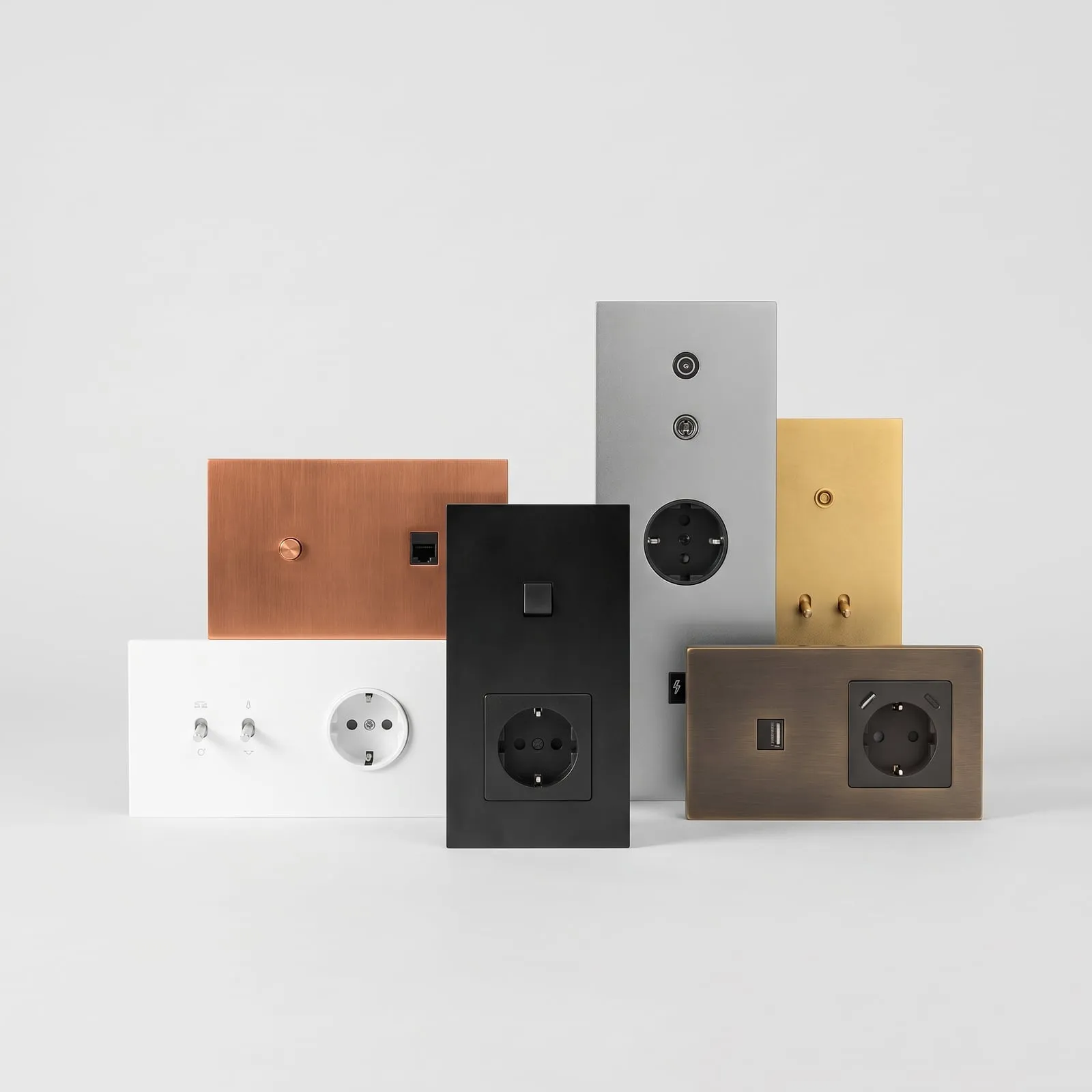 Designer wall switch and socket plates in brushed steel, copper, brass, black and white