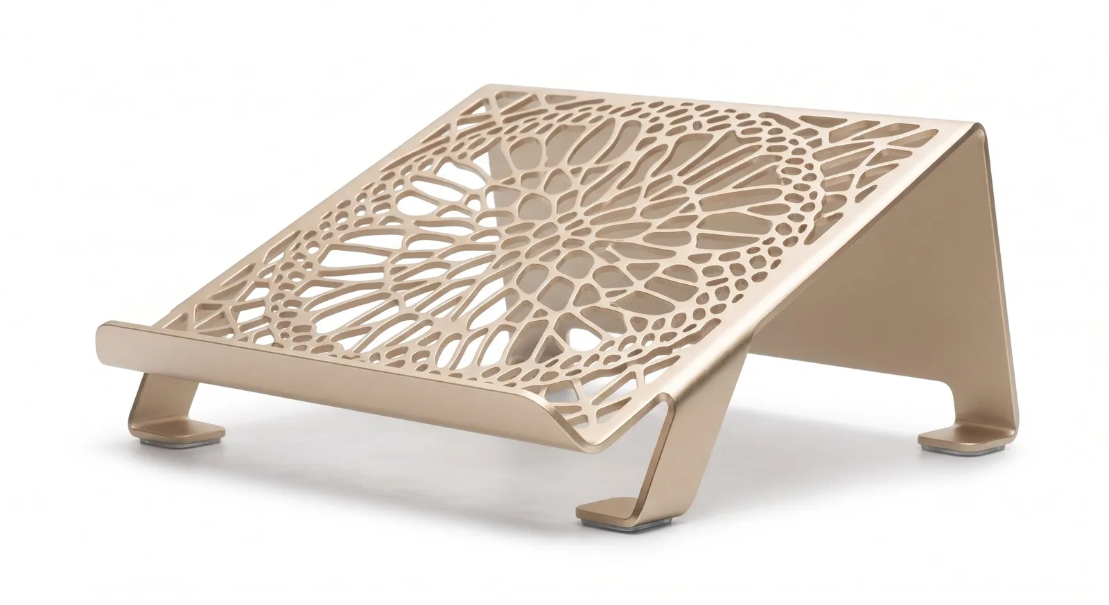 An aluminum laptop stand with a laser-cut pattern, bent and anodized soft gold.
